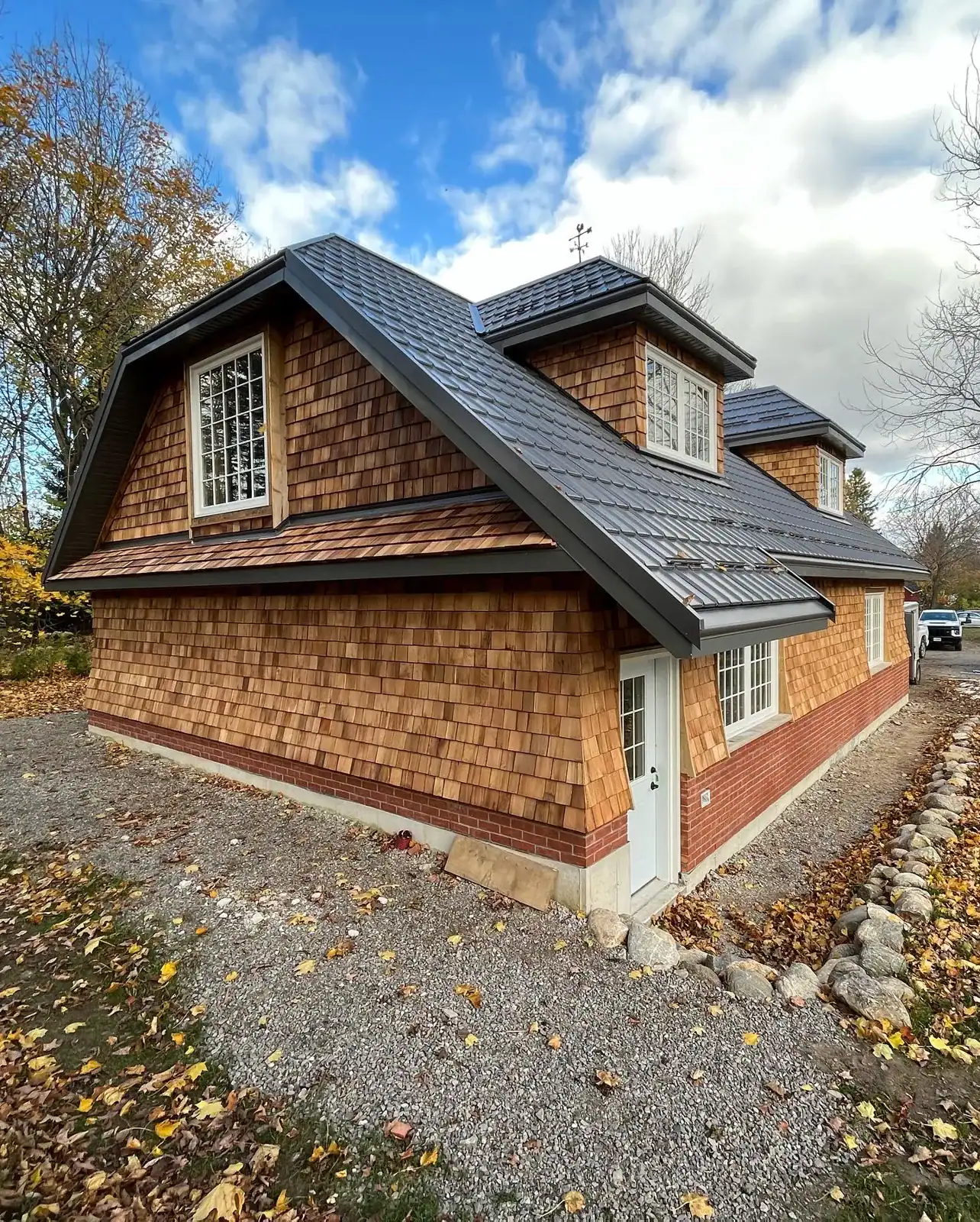 Cedar shake carriage house with dormers