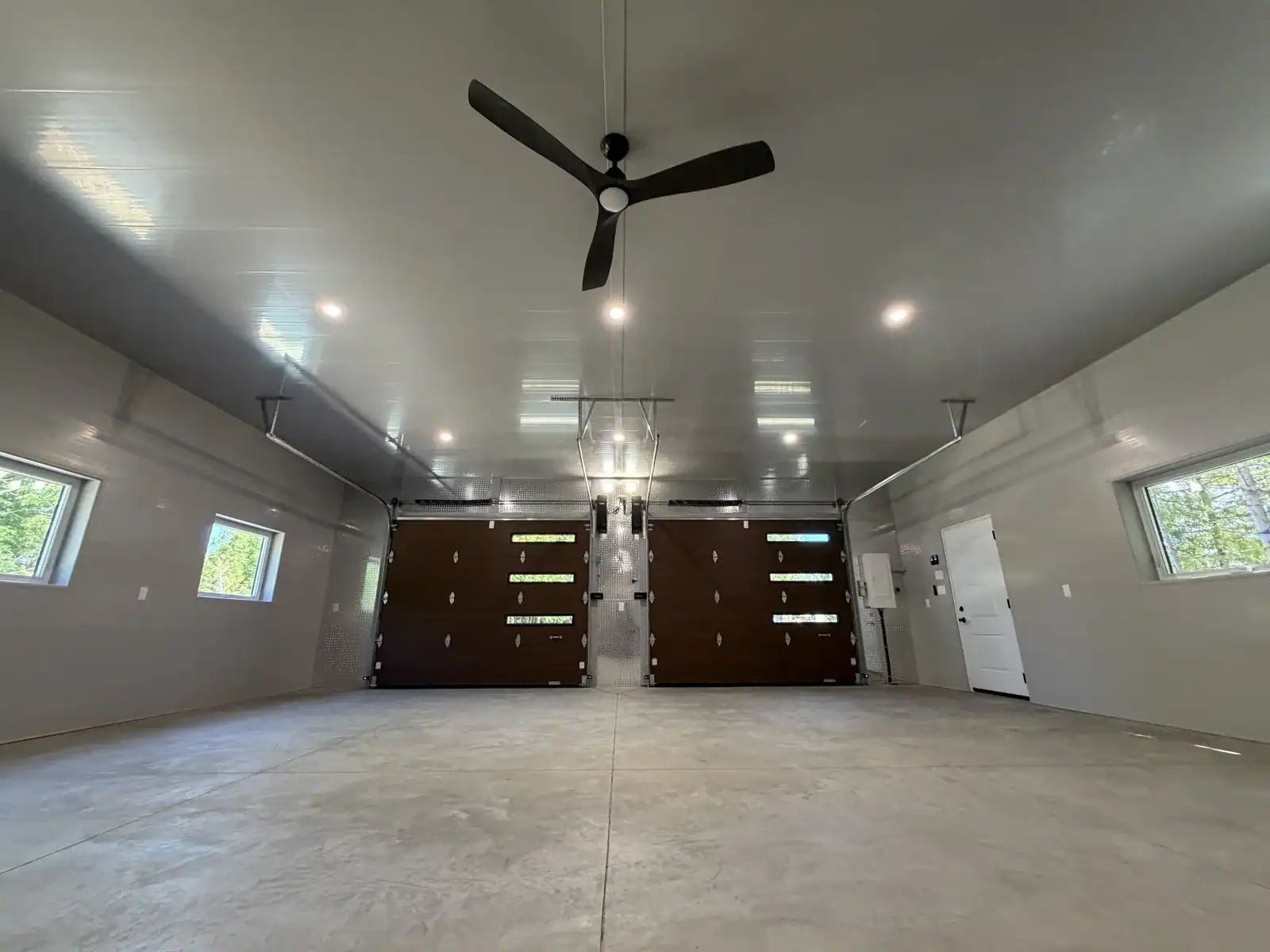 Finished garage interior with insulated overhead doors