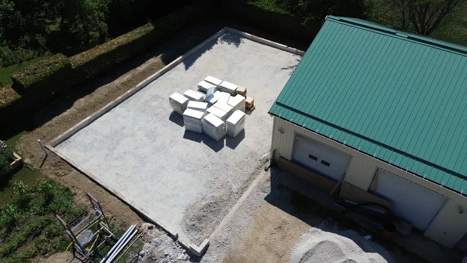 Aerial view of a finished workshop showing standing-seam metal roof and siding