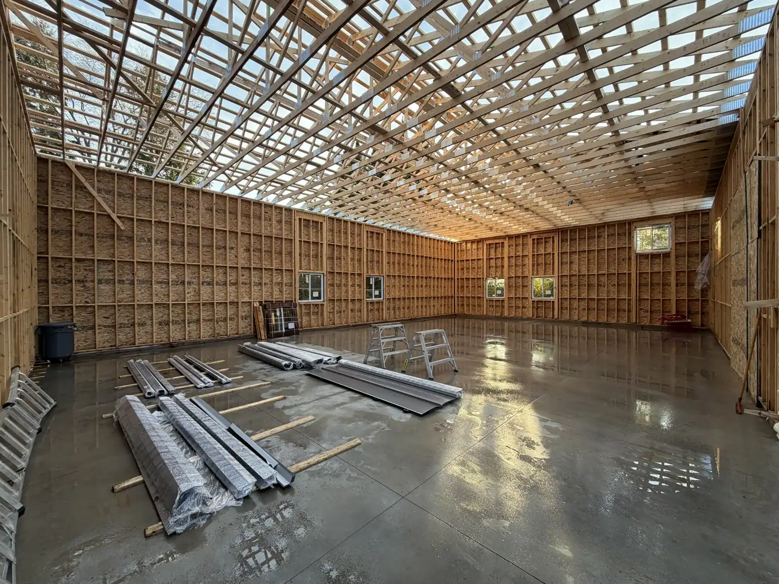 Large clear-span shop interior with freshly poured concrete slab