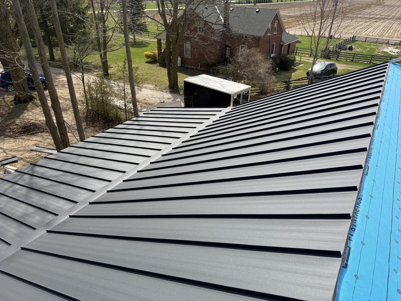 Standing seam roof on a farmhouse with double pitch