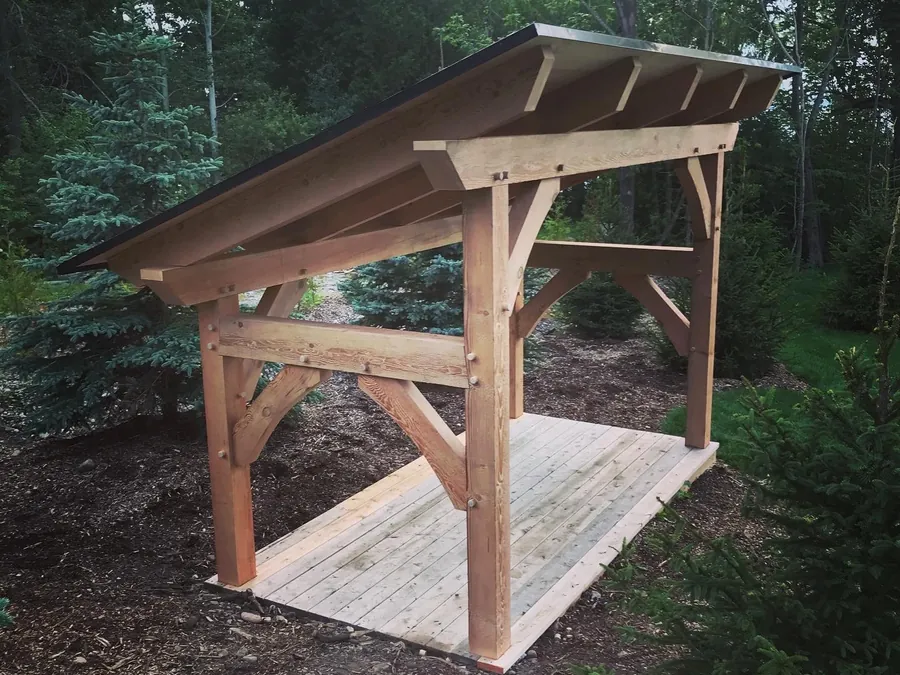 Freestanding timber frame pavilion with a plank floor