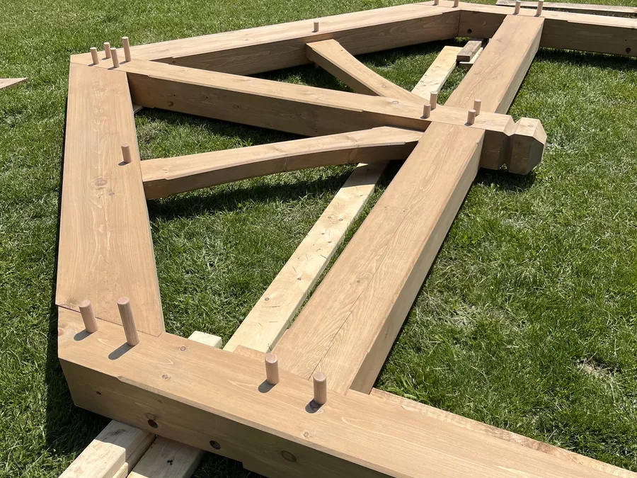 Mortise-and-tenon bent laid out on the grass before raising
